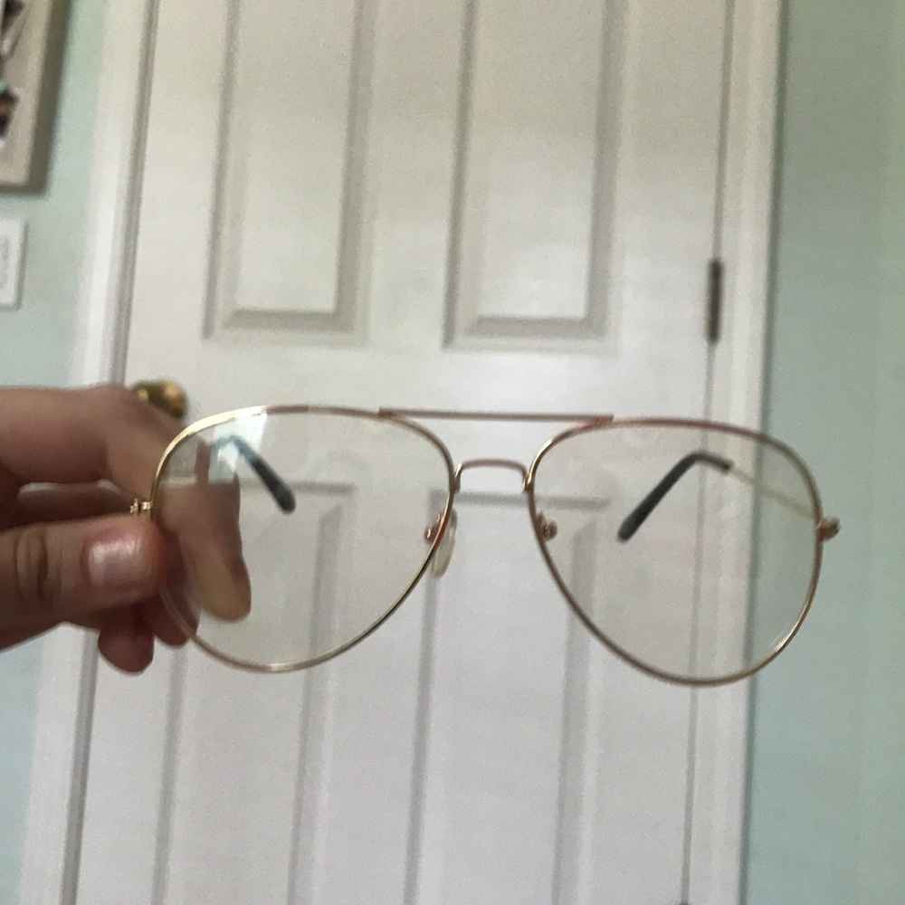 clear sunglasses with a gold rim.